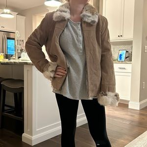 Leather coat with fur around collar, sleeves.